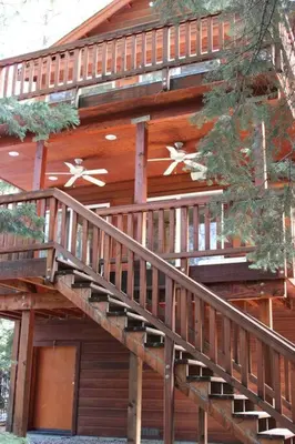 a wooden cabin with stairs on the side of it at Big Luxury South Lake Tahoe Home in South Lake Tahoe