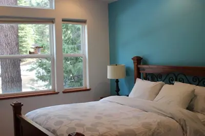 a bedroom with a bed and two windows at Big Luxury South Lake Tahoe Home in South Lake Tahoe