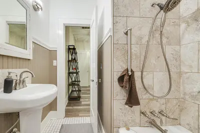 a bathroom with a shower and a sink at Sunny Turlock Cottage Walk to Downtown! in Turlock