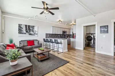 a living room with a couch and a ceiling fan at Mtn-View Apt with Deck in Historic Virginia City in Virginia City