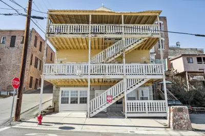 a building with a staircase on the side of it at Mtn-View Apt with Deck in Historic Virginia City in Virginia City