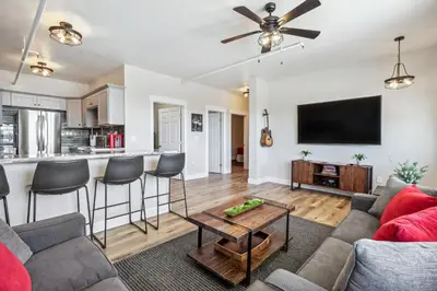 a living room with a couch and a table at Mtn-View Apt with Deck in Historic Virginia City in Virginia City