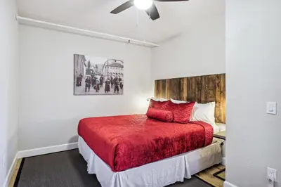 a bedroom with a bed with a red blanket at Mtn-View Apt with Deck in Historic Virginia City in Virginia City