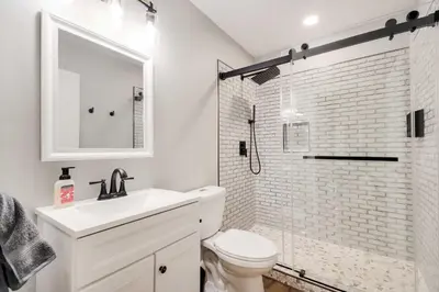 a bathroom with a toilet and a sink and a shower at Waterfront Mariposa Hideaway Hot Tub and Mtn Views! in Mariposa