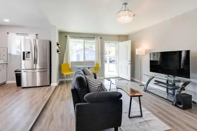 a living room with a couch and a refrigerator at Waterfront Mariposa Hideaway Hot Tub and Mtn Views! in Mariposa