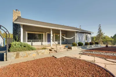 a house with a pathway leading to the front yard at Waterfront Mariposa Vacation Rental with Hot Tub in Mariposa