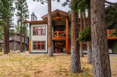 a house with trees in front of it at Cabins 1 in Mammoth Lakes
