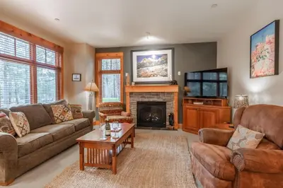 a living room with a couch and a fireplace at Cabins 1 in Mammoth Lakes
