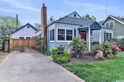a white house with a red door and a fence at Oasis East Sac Charming Home with Saltwater Pool and Casita in Sacramento
