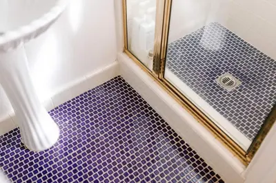 a bathroom with a shower with purple tile at Oasis East Sac Charming Home with Saltwater Pool and Casita in Sacramento