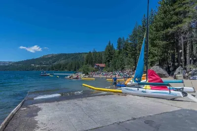 a boat with a sail on the shore of a lake at 3BR Tahoe Donner Cabin with HOA Perks like Pools Hot-Tub Minutes to Trails Lake Golf in Truckee
