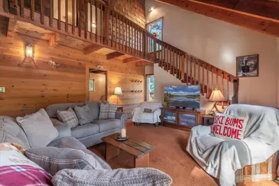 a living room with a couch and a staircase at 3BR Tahoe Donner Cabin with HOA Perks like Pools Hot-Tub Minutes to Trails Lake Golf in Truckee