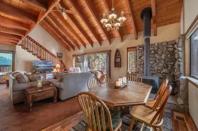 a living room with a table and a fireplace at 3BR Tahoe Donner Cabin with HOA Perks like Pools Hot-Tub Minutes to Trails Lake Golf in Truckee