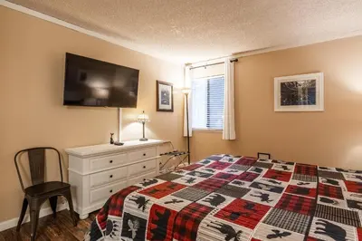 a bedroom with a bed and a dresser and a tv at Summit Forester #47 BLDG.2 Bedrm / 2 bath Ski in Ski Out! Steps to Chair 15 at Little Eagle Lodge! in Mammoth Lakes