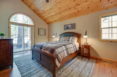a bedroom with a bed and two windows at 4 Mi to Downhill Ski Resort! Spacious Family Haven in Truckee