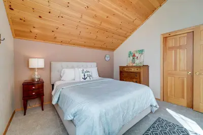 a bedroom with a bed and a wooden ceiling at 4 Mi to Downhill Ski Resort! Spacious Family Haven in Truckee