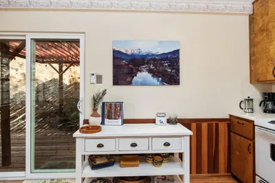 a kitchen with a white table and a window at Views, Hot Tub, Outdoor Shower, 15m from Sequoia in Three Rivers