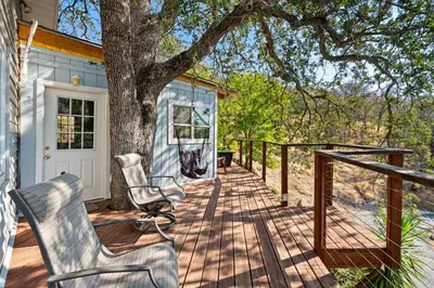 a deck with two chairs and a tree at Views, Hot Tub, Outdoor Shower, 15m from Sequoia in Three Rivers