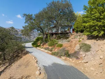a house on top of a hill with a road at Views, Hot Tub, Outdoor Shower, 15m from Sequoia in Three Rivers