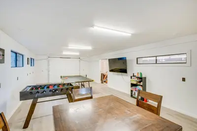 a room with a ping pong table and chairs at Pollock Pines Cabin Game Room with AandC and Heat! in Pollock Pines