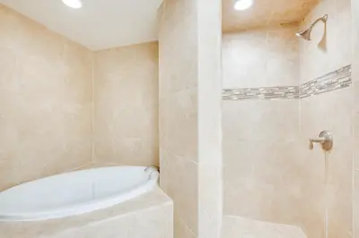 a bathroom with a tub and a shower stall at Pollock Pines Cabin Game Room with AandC and Heat! in Pollock Pines