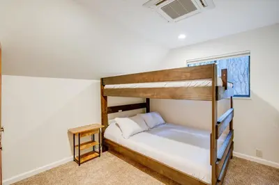 a bedroom with two bunk beds in a room at Pollock Pines Cabin Game Room with AandC and Heat! in Pollock Pines