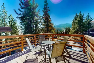 a patio with chairs and a table on a deck at Hilltop Lodge in Stateline