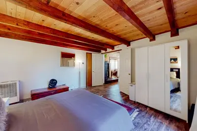 a bedroom with a bed and a wooden ceiling at Hilltop Lodge in Stateline