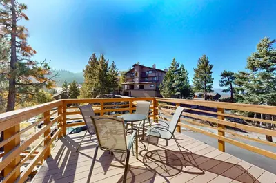 a patio with chairs and a table on a balcony at Hilltop Lodge in Stateline