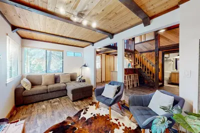 a living room with a couch and two chairs at Hilltop Lodge in Stateline