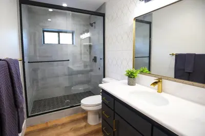 a bathroom with a shower and a sink and a toilet at High End A-Frame - Hot Tub - Awesome Views - Yosemite - Electric Vehicle Friendly - Sleeps 10 in Oakhurst