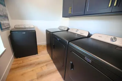 a laundry room with a washer and dryer at High End A-Frame - Hot Tub - Awesome Views - Yosemite - Electric Vehicle Friendly - Sleeps 10 in Oakhurst