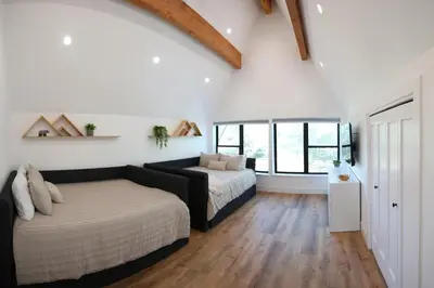 a bedroom with two beds and a large window at High End A-Frame - Hot Tub - Awesome Views - Yosemite - Electric Vehicle Friendly - Sleeps 10 in Oakhurst