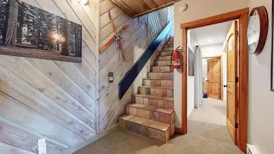 a hallway with a wooden wall with stairs in a house at Val D'Isere #8 condo in Mammoth Lakes
