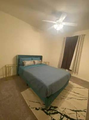 a bedroom with a bed and a ceiling fan at Cozy hideaway 30 miles to Mt Rose Ski, Tahoe/ Reno in Reno