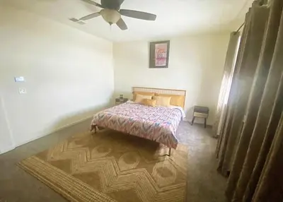 a bedroom with a bed and a ceiling fan at Cozy hideaway 30 miles to Mt Rose Ski, Tahoe/ Reno in Reno