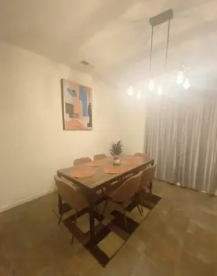a dining room with a wooden table and chairs at Cozy hideaway 30 miles to Mt Rose Ski, Tahoe/ Reno in Reno