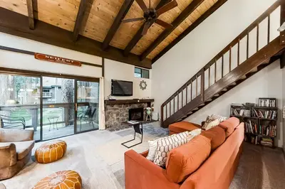 a living room with a couch and a fireplace at Lakeland Village South Lake Tahoe in South Lake Tahoe