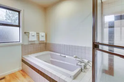 a white tub in a bathroom with a window at Remarkable Roundhouse Retreat in Truckee