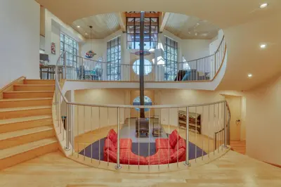 a spiral staircase with red chairs in a room at Remarkable Roundhouse Retreat in Truckee