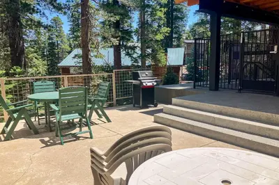 a patio with chairs and a table and a grill at Western Slopes Villas 3 in Mammoth Lakes