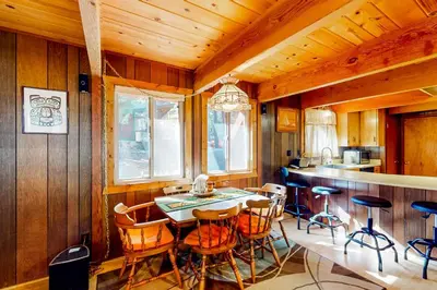 a dining room with a table and some chairs at Tranquil Treehouse Haven in Tahoe City