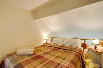 a bedroom with a bed with two pillows on it at Mountain Condo with Fireplace in Kirkwood Ski Resort in Kirkwood