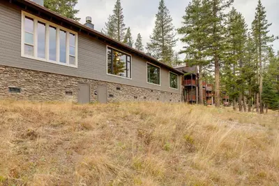 a house in the middle of a field with trees at Mountain Condo with Fireplace in Kirkwood Ski Resort in Kirkwood