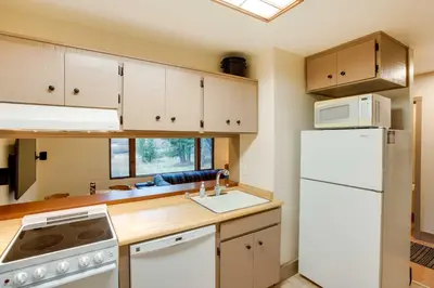 a kitchen with white appliances and a white refrigerator at Mountain Condo with Fireplace in Kirkwood Ski Resort in Kirkwood