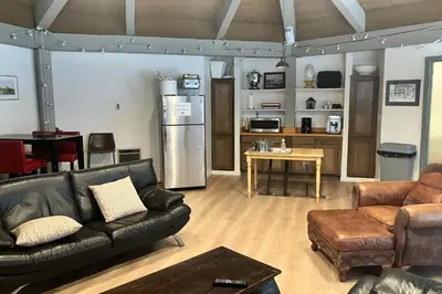 a living room with a black leather couch and a table at Sierra Park Villas 11 C in Mammoth Lakes