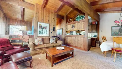 a living room with a couch and a table at Villa de los Pinos #40 condo in Mammoth Lakes