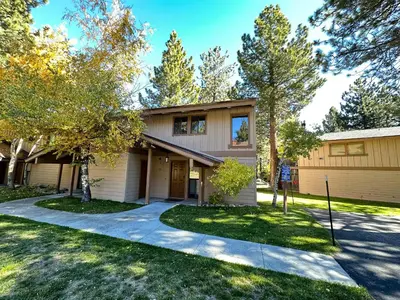 a house with a driveway in front of it at Villa de los Pinos #40 condo in Mammoth Lakes