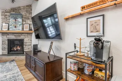 a living room with a fireplace and a table at New Listing 2 bedroom +Loft 2 bath Summit E Bldg. #8 condo sleeps 8, Steps to Eagle Lodge/Chair #15 in Mammoth Lakes