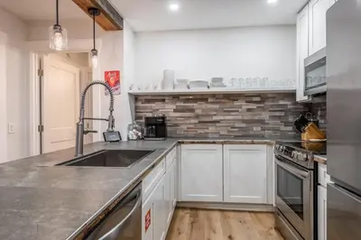 a kitchen with white cabinets and a sink at New Listing 2 bedroom +Loft 2 bath Summit E Bldg. #8 condo sleeps 8, Steps to Eagle Lodge/Chair #15 in Mammoth Lakes